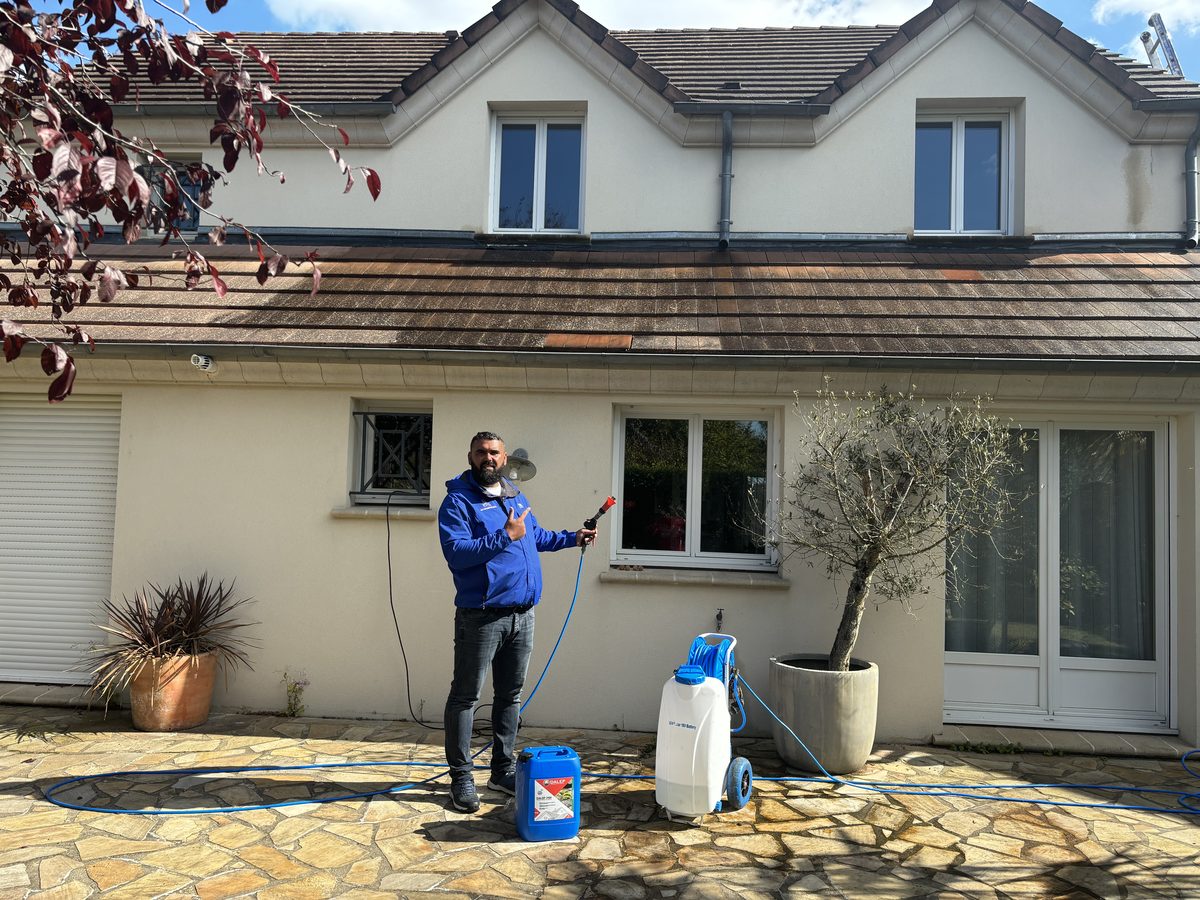Kevin Paumard prépare l'application d'un traitement hydrofuge devant un pavillon